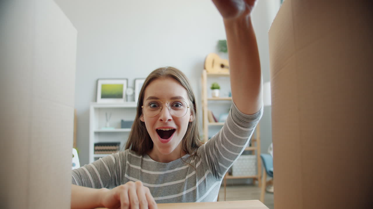 Excited Woman Unpacking Moving Boxes