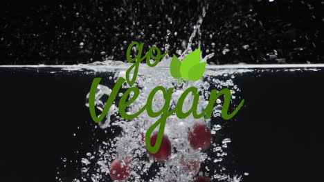 animation of go vegan text over fruit falling in water background