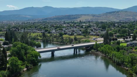 orbiting aerial shot of a bridge crossing the spokane river in washington state