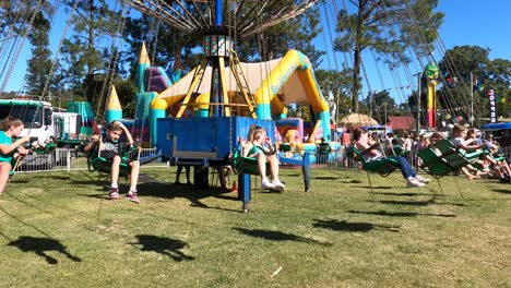 group performs traditional maypole dance in sunny park