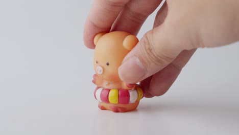 hand playing with miniature pig toy figure