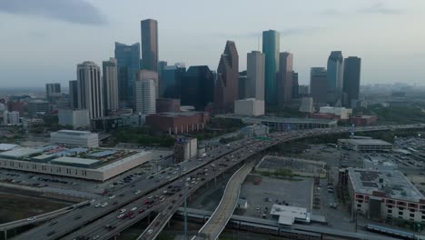Trucking-forward-and-pedestaling-down-drone-shot-of-the-Houston-skyline