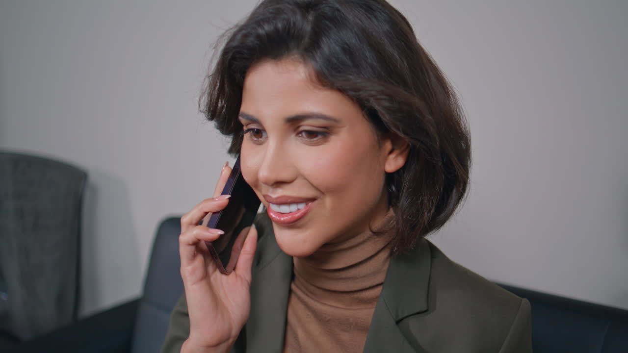 Focused woman negotiating cellphone sitting office closeup. Phone conversation