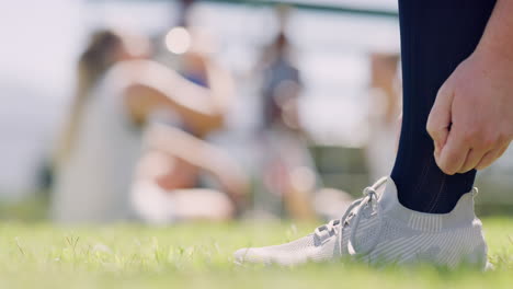 closeup of a sportsperson tying shoelaces