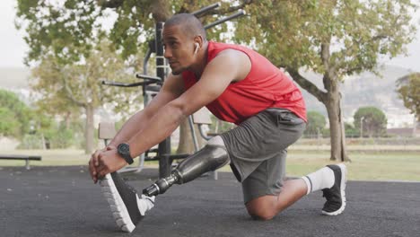 side view man with prosthetic leg stretching