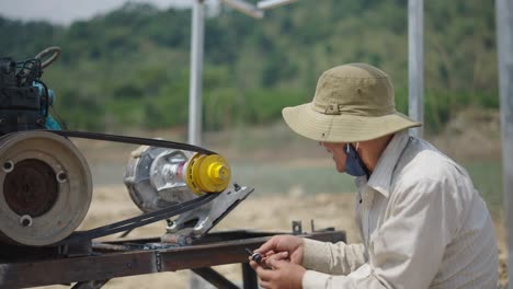 worker repairing machinery outdoors