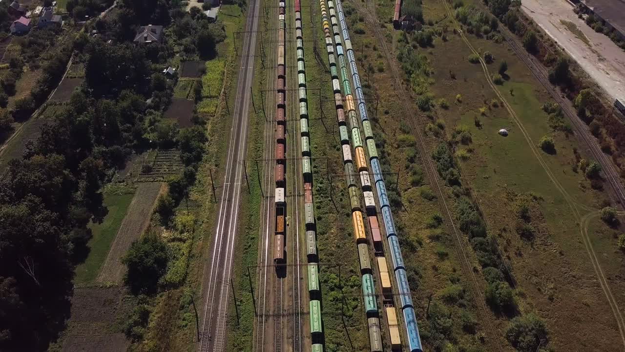 Flying above industrial railroad station with cargo trains 01