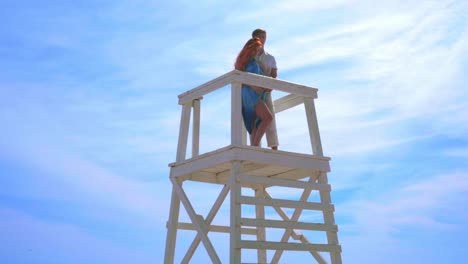 love couple hugging on sky background. romantic couple on watchtower