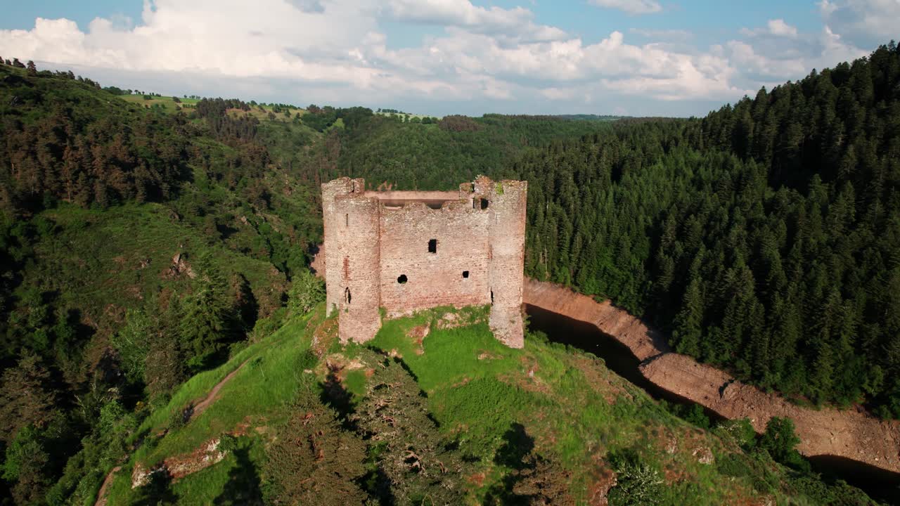 aerail shot around Alleuze Castle at sunset, Cantal departement, auvergne rhone alpes region, france