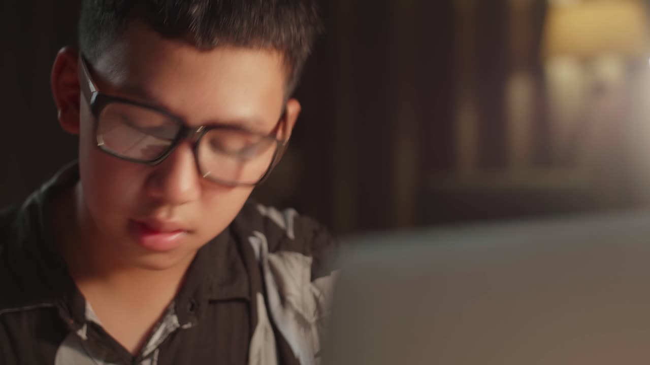 Close Up Asia Teenage Boy Learning Online From Laptop At Night