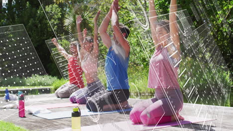 yoga group practicing sun salute on wooden deck, displaying finance charts and currency data