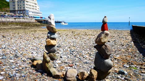 colourful rocks tower arrangement balanced on sunny llandudno beach seaside shoreline