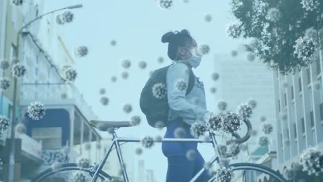 animation of macro covid-19 cells floating over asian woman wearing a face mask