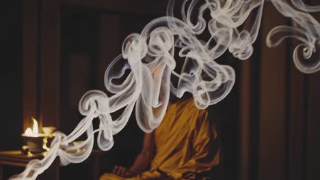 monk meditating with incense smoke