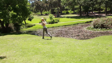 a woman runs in the park as the camera follows her