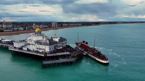 aerial footage captures waverley, the world's last sea-going paddle steamer, gracefully docked at the pier