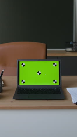 Laptop with Green Screen in an Office Setting