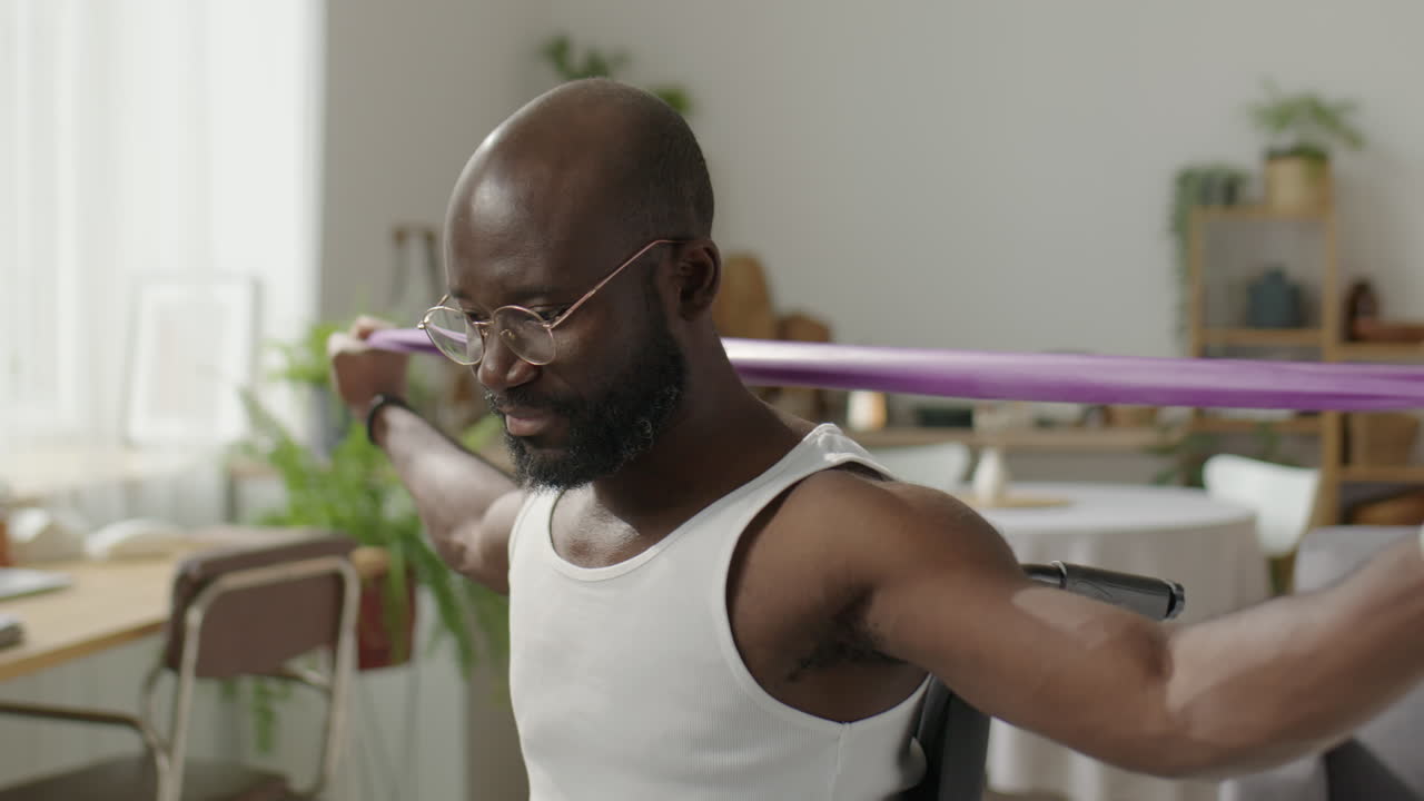 Man with Disability Training with Resistance Band at Home