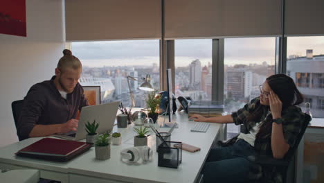 overworked people using computers at evening workplace. busy man typing laptop