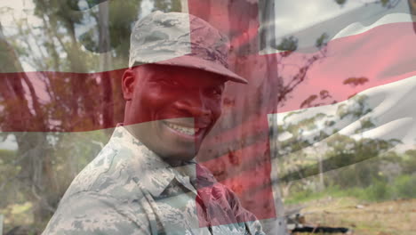 digital composition of waving england flag against portrait of soldier smiling at training camp