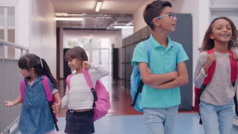 diverse group of school students of different ages walking the school's hallway