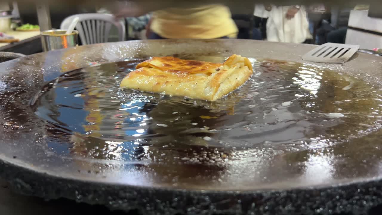 Close up shot of Mughlai paratha romanized Moglai is a popular Bengali street food of soft fried bread enhanced by a stuffing of keema minced meat, egg, onions and pepper.