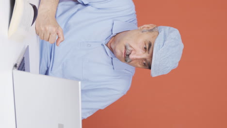 Vertical-video-of-Old-man-closing-laptop-with-angry-expression.