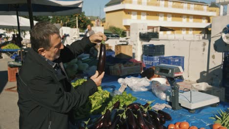 man choosing eggplant