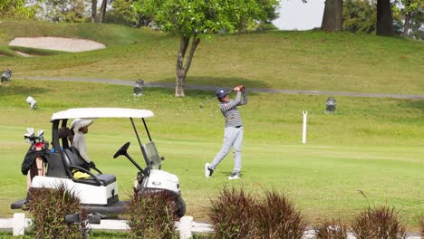 golfer executing a swing on a sunny day.