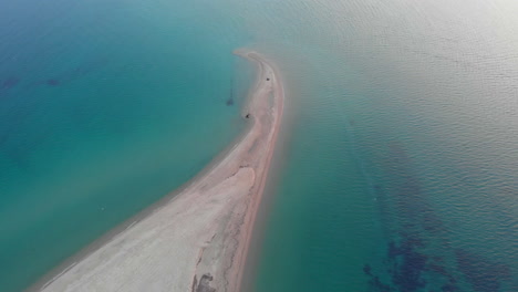 orbit drone video over empty sand beach sea cape blue water greece