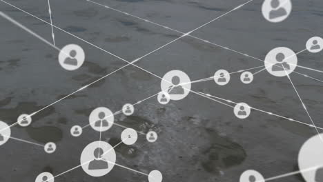 network of connected user icons animation over aerial view of landscape