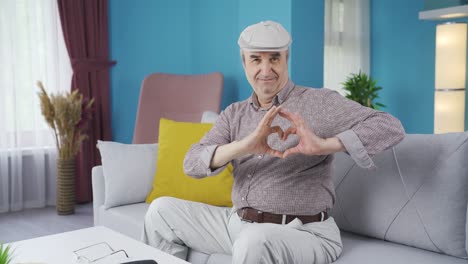 Cute-old-man-making-heart-sign-at-camera.