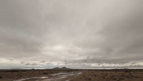 timelapse, thick grey clouds blow in mojave desert before winter storm