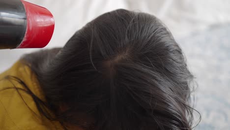 woman getting her hair blow-dried at a salon