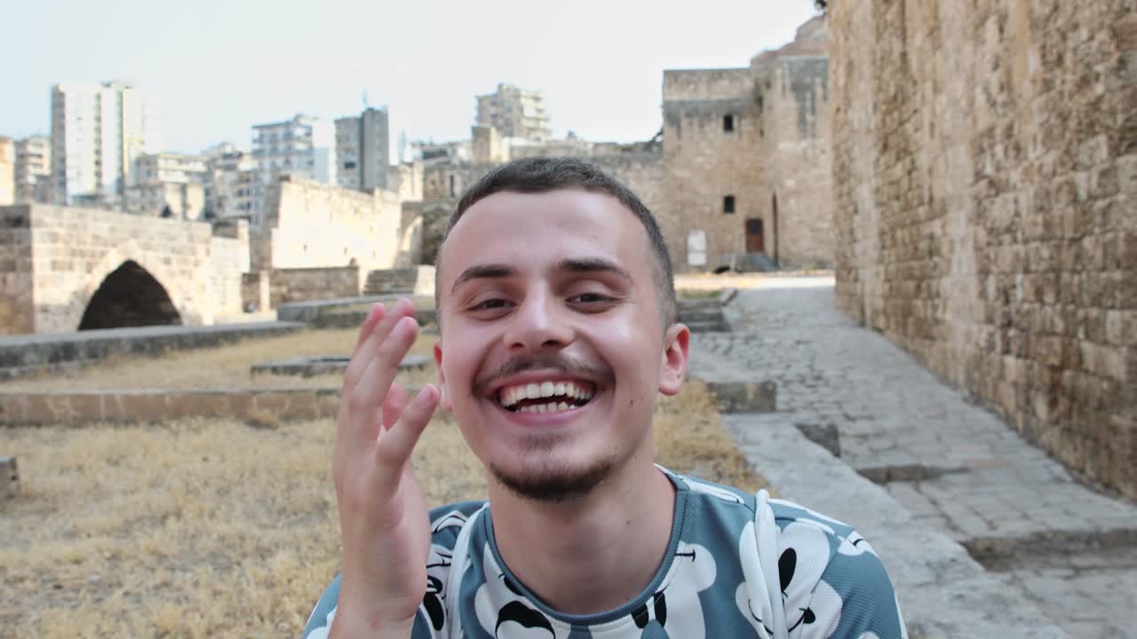 Funny Man At The Citadel of Raymond de Saint-Gilles In Tripoli, Lebanon Laughs As He Talks In Front Of Camera