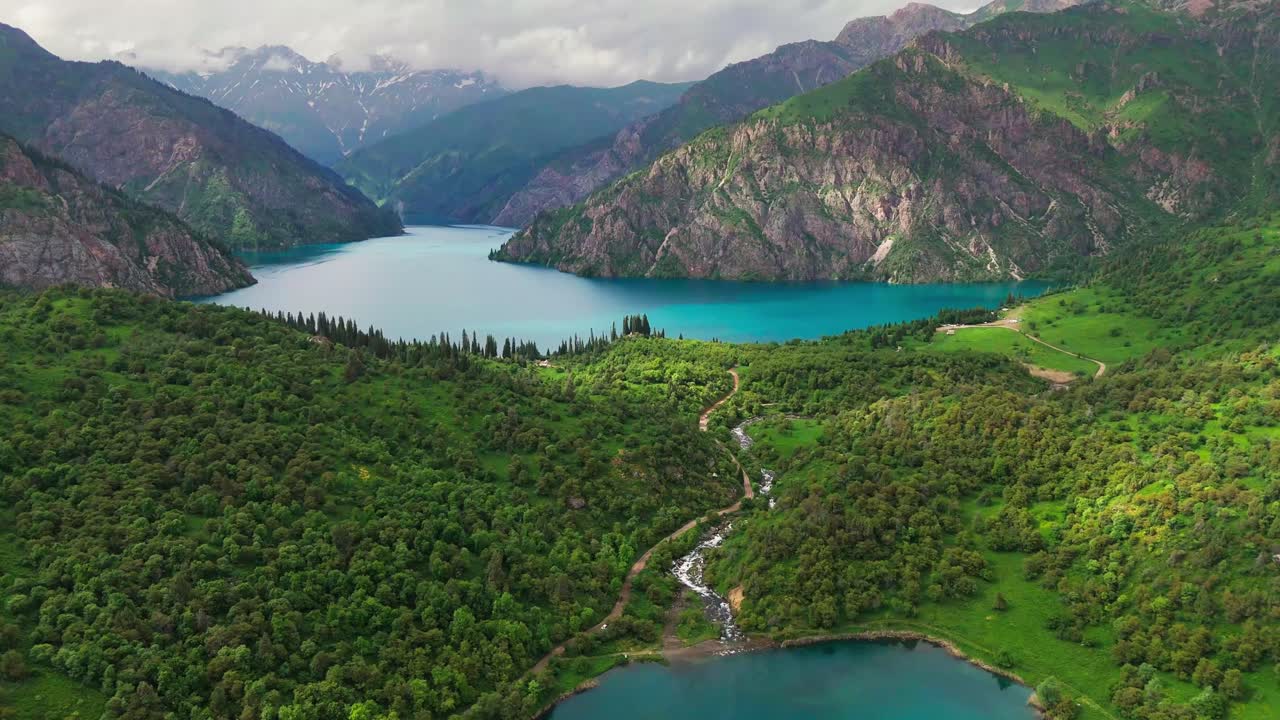 aerial view of sary chelek lake in Kyrgyzstan drone fly above scenic landscape with mountains in natural reserve