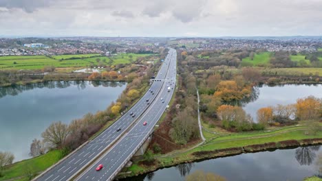 Aerial-drone-cinematic-video-footage-of-the-M1-Motorway-near-the-city-of-Wakefield,-West-Yorkshire,-UK