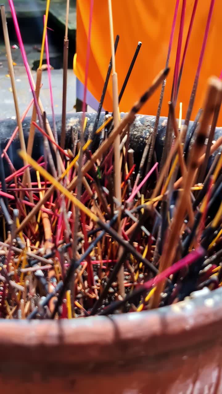 Balinese offerings and burning incense in a temple in Ubud. Close up