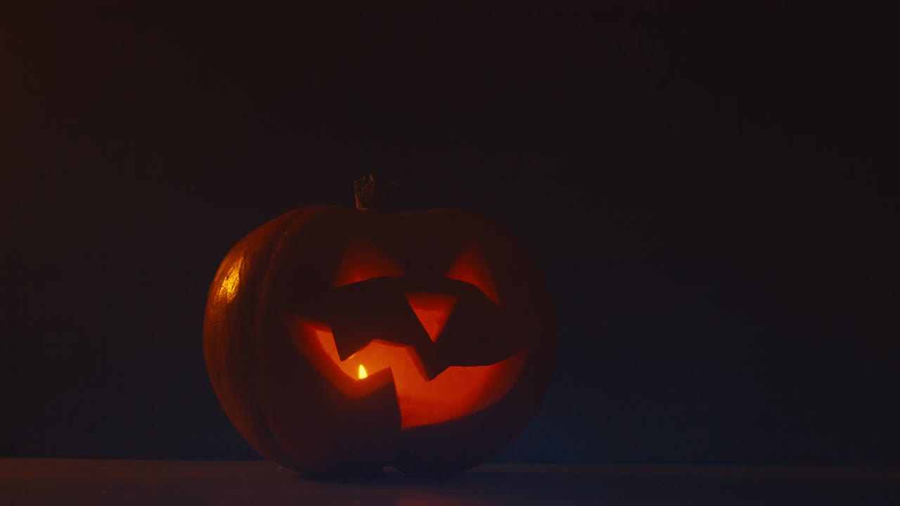 cinemagraph - cu halloween tallado calabaza jack-o-lanterna con velas. foto en movimiento bucle sin costuras
