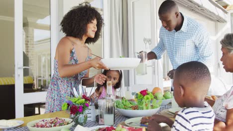 video of african american family spending time together and having dinner outside