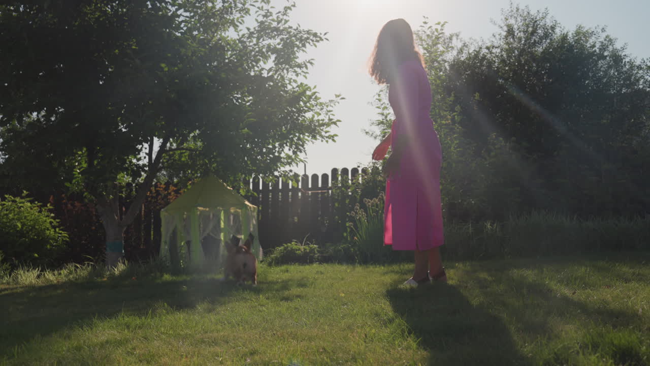 Caucasian Mother Walking Toward Playhouse In Sunlit Garden, Curious Approach And Thoughtful Pause, Path Lined With Flowers And Soft Shade, Warm Lensflare And Peaceful Backyard Atmosphere