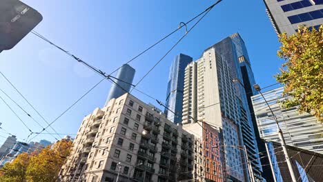 urban street scene with skyscrapers and tram wires