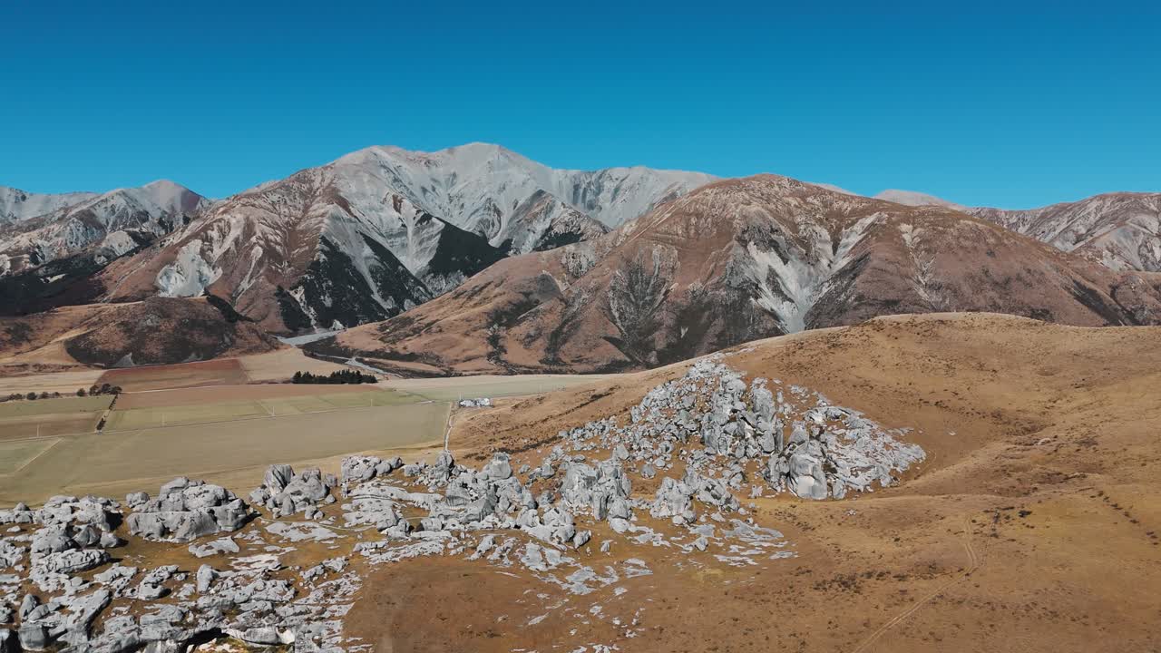 Wide drone establishing of sacred Castle Hill rock structures in Arthur’s Pass, New Zealand