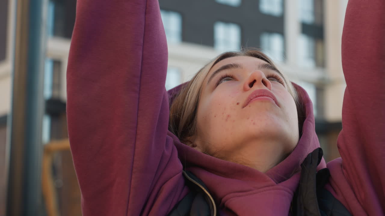 Close up view of fitness trainer hands firmly gripping horizontal bar to maintain balance and focus during outdoor urban gym workout, showcasing control strength and preparation before pull up