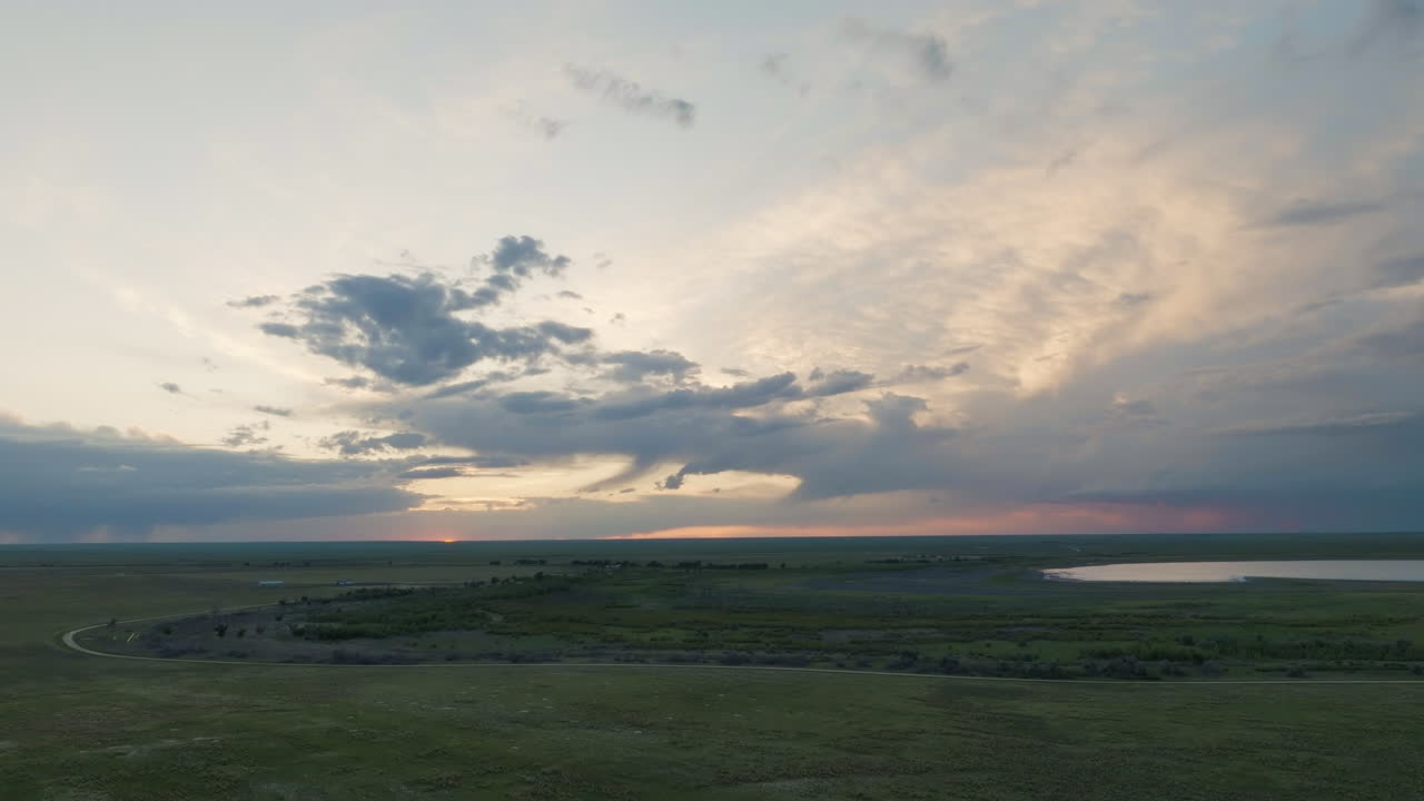 The Sun Setting Over The Colorado Prairie Grassland And Lakes