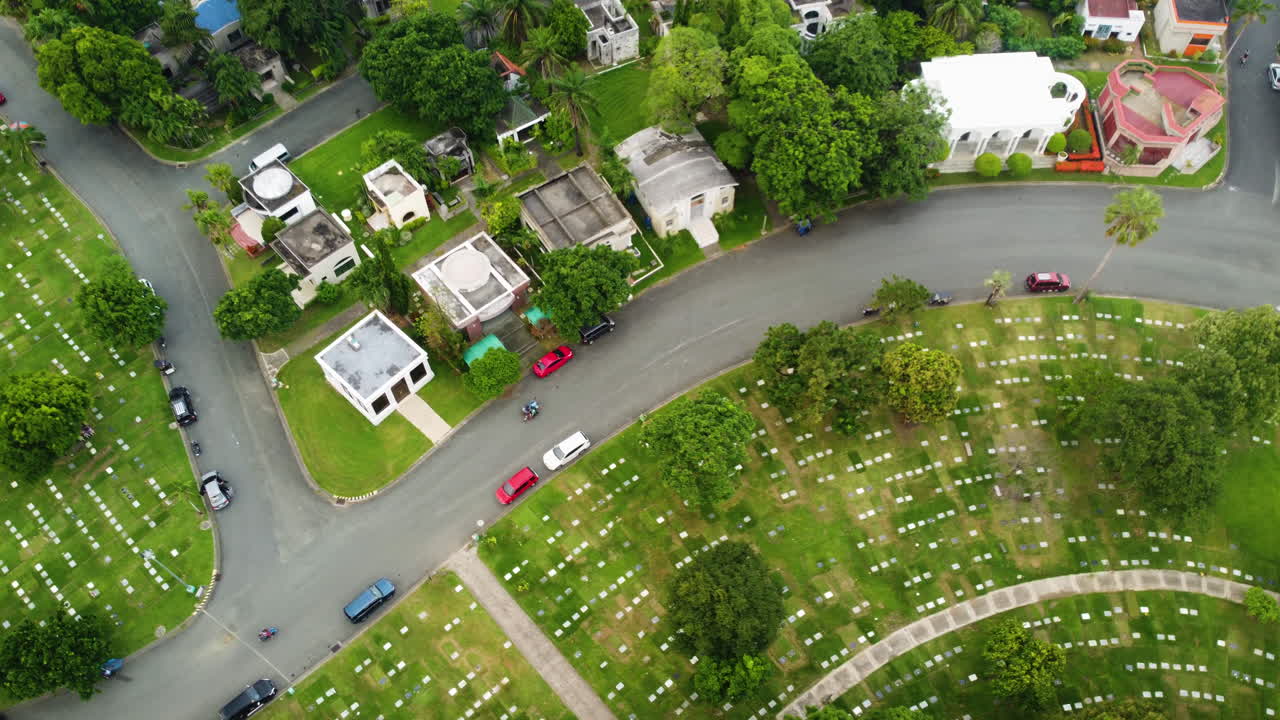 Aerial view following motorbikes in the neighborhoods of Parañaque, Philippines
