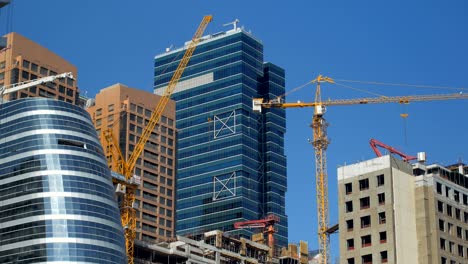 modern skyscrapers and unfinished building in a downtown in summer