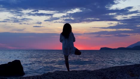 girl performing spiritual yoga pose on the beach at sunset zen wellness in front of sea and beautiful sky