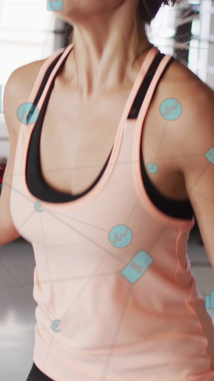 Vertical video: Woman starting rapid skipping on mat for cardio, view rising, AR charts floating