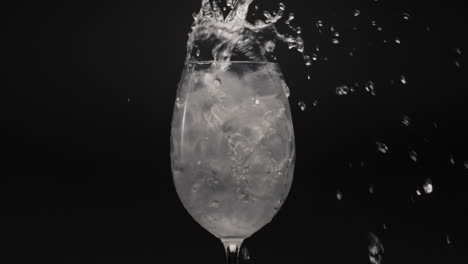 mineral water pouring ice glass closeup. preparing cocktails and beverages
